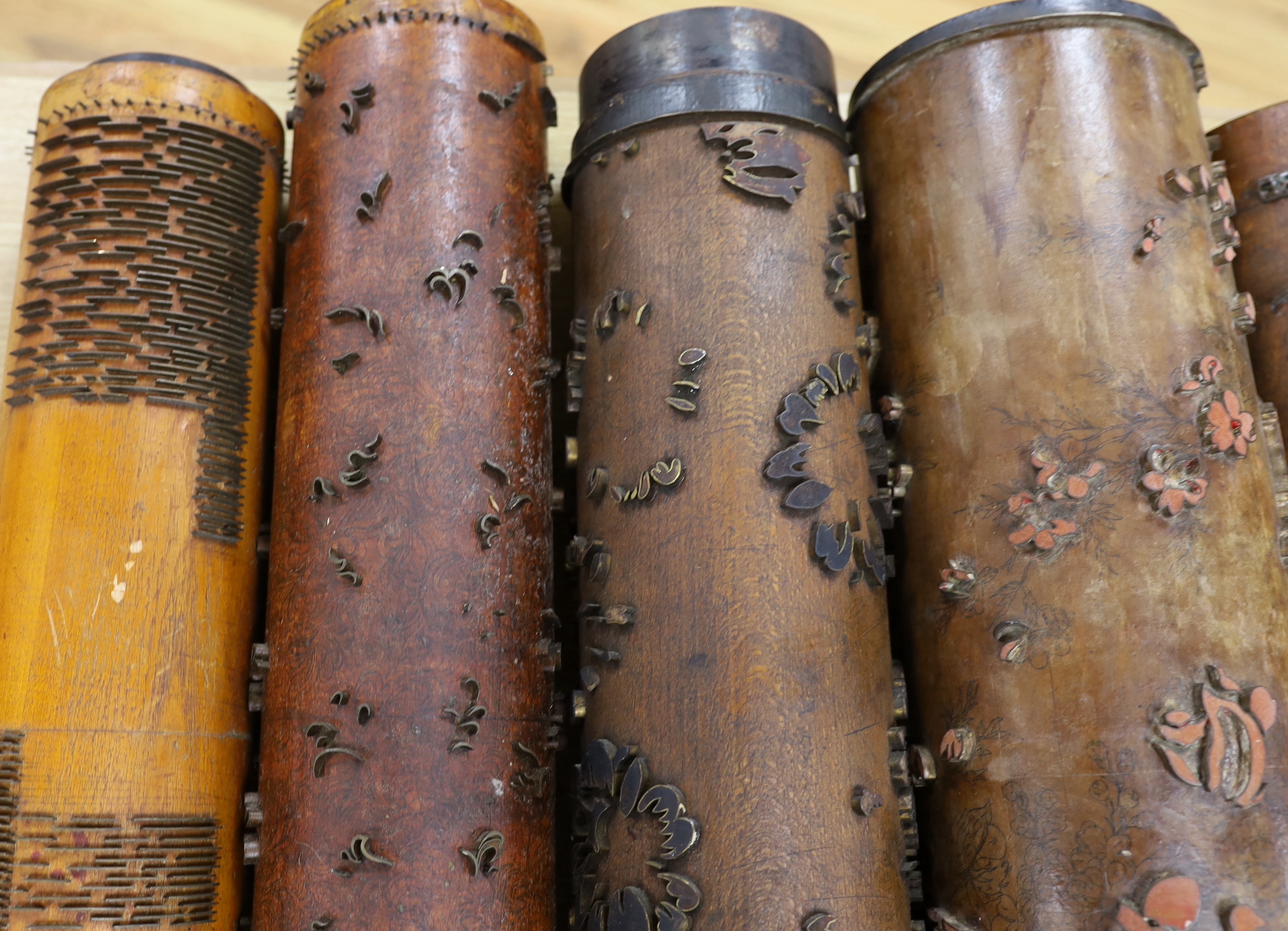Five USA wooden print rollers for wallpaper, late 19th century, including a UWPC (United Wall Paper Craftsmen of North America) example, another stamped with serial numbers, longest 60.5cm